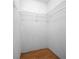 Empty closet with white wire shelving and hardwood floors at 23 Larch Crse, Ocala, FL 34480