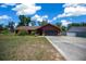 Charming single-story home with a well-manicured lawn and a long concrete driveway leading to an attached garage at 23 Larch Crse, Ocala, FL 34480