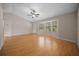 Bright living room with hardwood flooring, a ceiling fan, and a bay window that brings natural light into the space at 23 Larch Crse, Ocala, FL 34480