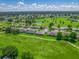 Aerial view showcases a peaceful residential neighborhood with lush greenery and a golf course at 2478 Nw 53Rd Avenue Rd, Ocala, FL 34482