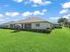 A well-manicured lawn and covered lanai create an inviting outdoor space for relaxation and enjoyment at 2478 Nw 53Rd Avenue Rd, Ocala, FL 34482