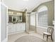 Elegant bathroom with a double vanity, glass-enclosed shower, and decorative wallpaper at 2478 Nw 53Rd Avenue Rd, Ocala, FL 34482