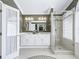 Elegant bathroom with a double vanity, glass-enclosed shower, and decorative wallpaper at 2478 Nw 53Rd Avenue Rd, Ocala, FL 34482