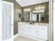 Bathroom vanity with double sinks, decorative wallpaper, and decorative mirror and lighting at 2478 Nw 53Rd Avenue Rd, Ocala, FL 34482