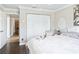 Bedroom featuring white furniture, wood floors, and access to the hallway at 2478 Nw 53Rd Avenue Rd, Ocala, FL 34482