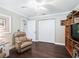 Bedroom features hardwood floors, a recliner, and a closet, offering comfort and functionality at 2478 Nw 53Rd Avenue Rd, Ocala, FL 34482