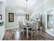 Bright dining room featuring a large window, hardwood floors, chandelier lighting, and a table with seating at 2478 Nw 53Rd Avenue Rd, Ocala, FL 34482