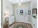 Welcoming entryway with stylish decor, featuring hardwood floors, decorative mirror and chandelier lighting at 2478 Nw 53Rd Avenue Rd, Ocala, FL 34482