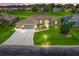 Beautiful home featuring a well-manicured lawn, arched windows, a three-car garage, and lovely landscaping at 2478 Nw 53Rd Avenue Rd, Ocala, FL 34482