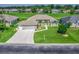Beautiful aerial view of a single-story home with a three car garage and lush landscaping at 2478 Nw 53Rd Avenue Rd, Ocala, FL 34482