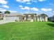 Charming one-story home featuring a well-maintained lawn, arched windows, and a three-car garage at 2478 Nw 53Rd Avenue Rd, Ocala, FL 34482