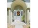 Inviting front door framed by elegant columns, with a decorative wreath and charming outdoor lighting at 2478 Nw 53Rd Avenue Rd, Ocala, FL 34482