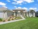 Charming one-story home showcasing beautifully landscaped flower beds, arched windows and inviting walkway at 2478 Nw 53Rd Avenue Rd, Ocala, FL 34482