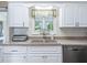 White cabinets with a stainless steel dishwasher, bread toaster, and kitchen window at 2478 Nw 53Rd Avenue Rd, Ocala, FL 34482