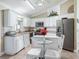 A well lit kitchen, with white cabinets and stainless steel appliances at 2478 Nw 53Rd Avenue Rd, Ocala, FL 34482