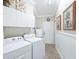 Well-organized laundry room with washer, dryer, and plenty of storage cabinets for convenience at 2478 Nw 53Rd Avenue Rd, Ocala, FL 34482
