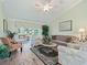 Cozy living room featuring hardwood floors, vaulted ceilings, comfortable seating, and lots of light at 2478 Nw 53Rd Avenue Rd, Ocala, FL 34482