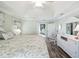Airy main bedroom showcasing tray ceiling, wood floors, and white furnishings at 2478 Nw 53Rd Avenue Rd, Ocala, FL 34482