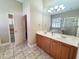 Bathroom with a double vanity, large mirror, and clear glass shower providing a spa-like feel at 2515 Se 19Th Cir, Ocala, FL 34471