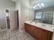 Bathroom with double vanity, tile flooring, a glass-enclosed shower, and ample counter space at 2515 Se 19Th Cir, Ocala, FL 34471
