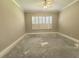 Bedroom with neutral colored walls, crown moulding, shuttered window, and ceiling fan at 2515 Se 19Th Cir, Ocala, FL 34471