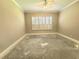 Bedroom featuring shutters on the window and awaiting flooring for a fresh, modern look at 2515 Se 19Th Cir, Ocala, FL 34471
