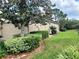Landscaped home exterior with bushes and trees in mulch beds, and well kept lawn at 2515 Se 19Th Cir, Ocala, FL 34471