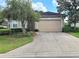 Charming single-story home with a well-manicured lawn, a two-car garage, and mature trees at 2515 Se 19Th Cir, Ocala, FL 34471