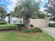 Beautiful front yard with large tree and landscaping, driveway leading to garage and walkway to front door at 2515 Se 19Th Cir, Ocala, FL 34471