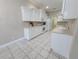 Spacious kitchen with tile flooring, white cabinets, and modern appliances, perfect for cooking at 2515 Se 19Th Cir, Ocala, FL 34471