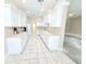 Well-lit kitchen featuring white cabinets, tile flooring, and a functional layout at 2515 Se 19Th Cir, Ocala, FL 34471