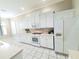 Well-lit kitchen featuring white appliances and ample cabinet space for storage and cooking at 2515 Se 19Th Cir, Ocala, FL 34471