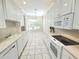 Eat-in kitchen with white cabinets, modern appliances, and garden view at 2515 Se 19Th Cir, Ocala, FL 34471