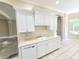 Bright kitchen with white cabinets, neutral countertops, and updated appliances at 2515 Se 19Th Cir, Ocala, FL 34471