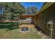 Expansive backyard featuring a covered deck, fire pit, and mature shade trees at 3065 Se 142Nd Ln, Summerfield, FL 34491