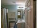 Inviting bathroom showcases a shower with tub, stylish fixtures, and convenient toilet cabinet at 3065 Se 142Nd Ln, Summerfield, FL 34491