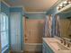 Bathroom showcasing a shower/tub combo, vanity, a mirror, and a window at 3065 Se 142Nd Ln, Summerfield, FL 34491