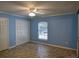 Bedroom with a window, fan, and a closet for storage at 3065 Se 142Nd Ln, Summerfield, FL 34491