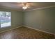 This spacious bedroom features tile flooring and a ceiling fan at 3065 Se 142Nd Ln, Summerfield, FL 34491