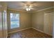 Neutral bedroom with a window bringing in natural light, fan, and a closet for storage at 3065 Se 142Nd Ln, Summerfield, FL 34491