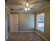 Bedroom with a view to the yard through a window bringing in natural light and fan at 3065 Se 142Nd Ln, Summerfield, FL 34491