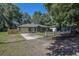 Charming single-story home featuring a well-manicured lawn and an attached garage at 3065 Se 142Nd Ln, Summerfield, FL 34491