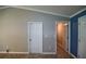 Neutral hallway with tile flooring, multiple doors, and easy access to different areas of the home at 3065 Se 142Nd Ln, Summerfield, FL 34491