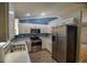 Modern kitchen includes stainless steel appliances, white cabinets, and sleek marble countertops at 3065 Se 142Nd Ln, Summerfield, FL 34491