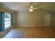 Spacious living room with tiled floors, ceiling fan and large window offering natural light and a view to the outside at 3065 Se 142Nd Ln, Summerfield, FL 34491