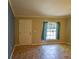 Bright living room with tile floors, a window with curtains, and a door, complemented by fresh paint at 3065 Se 142Nd Ln, Summerfield, FL 34491
