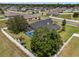 An aerial view captures the property's pool, backyard, and surrounding fenced-in yard, within the neighborhood at 3612 Se 47Th Ter, Ocala, FL 34480