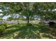 Sprawling backyard with mature trees, manicured lawn, and screened-in pool area, perfect for outdoor activities and enjoyment at 3612 Se 47Th Ter, Ocala, FL 34480