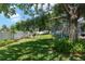 Beautiful backyard features a screened-in pool, lush landscaping, a white fence, and an outdoor seating area at 3612 Se 47Th Ter, Ocala, FL 34480