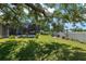 Expansive backyard with a screened pool, seating area, white fence, and mature trees for shade at 3612 Se 47Th Ter, Ocala, FL 34480